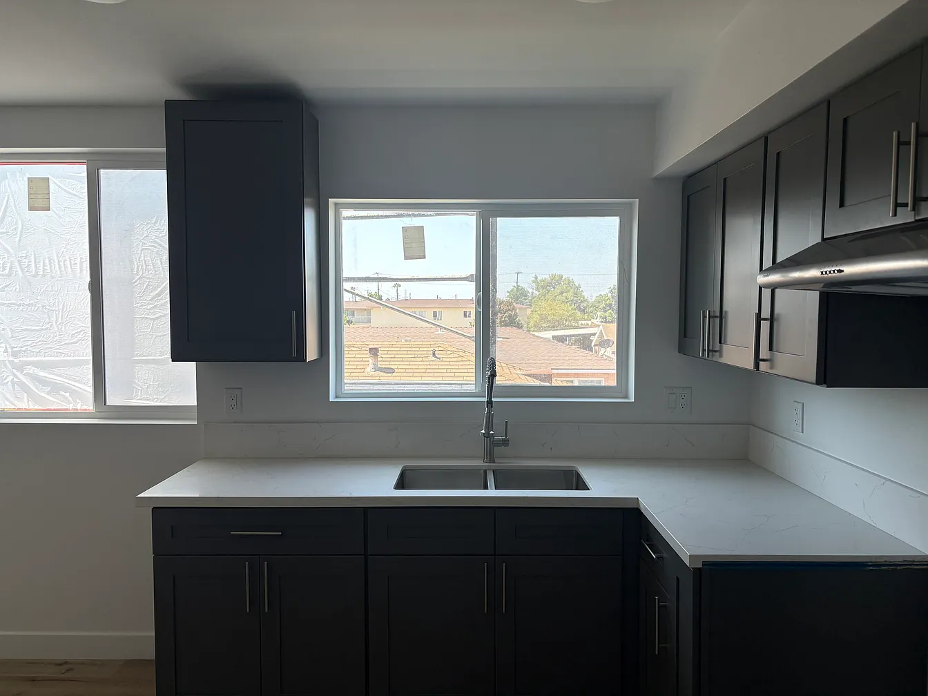 Quartz counters and shaker cabinetry in the kitchen